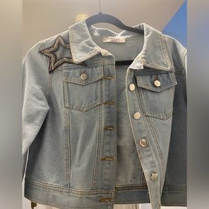 Light wash cropped denim jacket with star embellishments